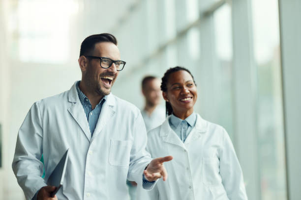 istock Happy doctors walking through hallway of a hospital. 2193646080