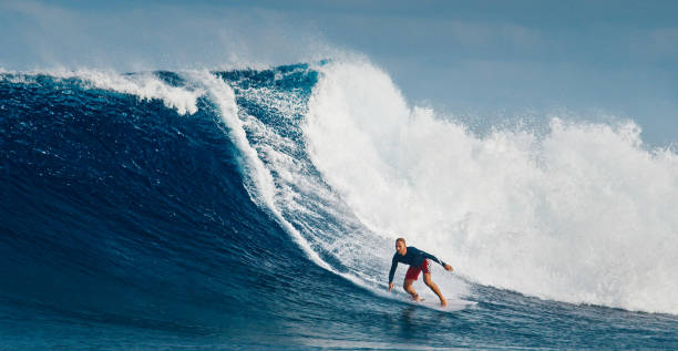 istock Pro surfer rides big wave in the Maldives 2193646549