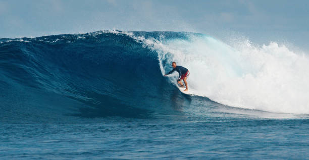 istock Pro surfer rides big wave in the Maldives 2193646572