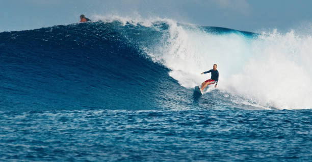 istock Pro surfer rides big wave in the Maldives 2193646574