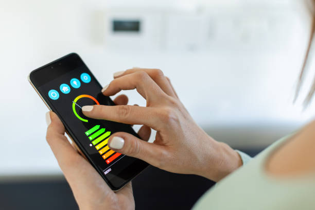 istock Close up of woman's hands controlling home temperature with a smart phone application 2193647429