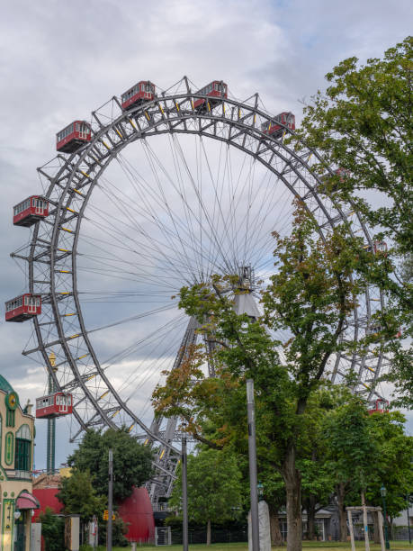 istock Historic Vienna Ferris Wheel with Classic Red Cabins Against a Cloudy Sky, Austria 2193649763