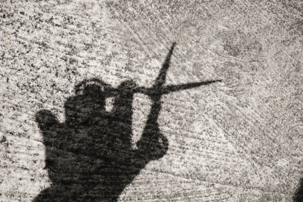 istock Silhouette of hand holding scissors in monochrome 2193650655