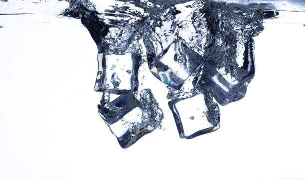 istock Splashing ice cubes scattered in water creating a dynamic air bubbles motion effect. Isolated white background. Ice Cubes hit water create air bubbles clear drink 2193651238