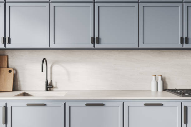 istock Modern kitchen interior with light blue cabinets, minimalist sink, and light marble countertop on a bright background. 3D Rendering 2193651311