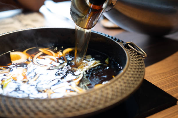 istock Pour black soup in to hot pot with many onion. 2193652054