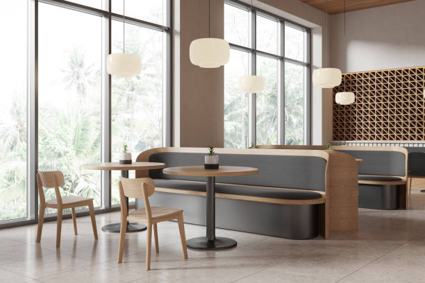 istock Modern cafe interior with wooden furniture and large windows overlooking greenery. 3D Rendering 2193653326