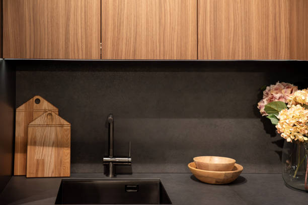 istock Modern faucet mounted on stone countertop near integrated kitchen sink 2193653453