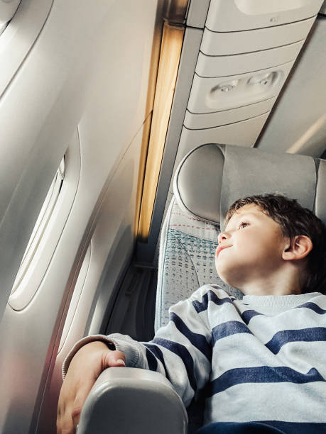 istock Little kid boy happy during flight on airplane 2193655197