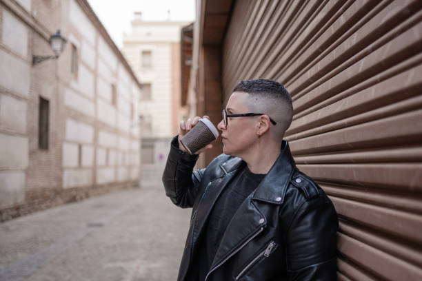 istock Lesbian woman drinking coffee in urban setting expressing masculinity 2193655514