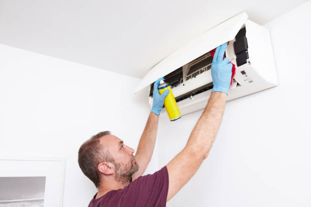 istock Man cleaning and maintaining air condition unit at home. 2193655941