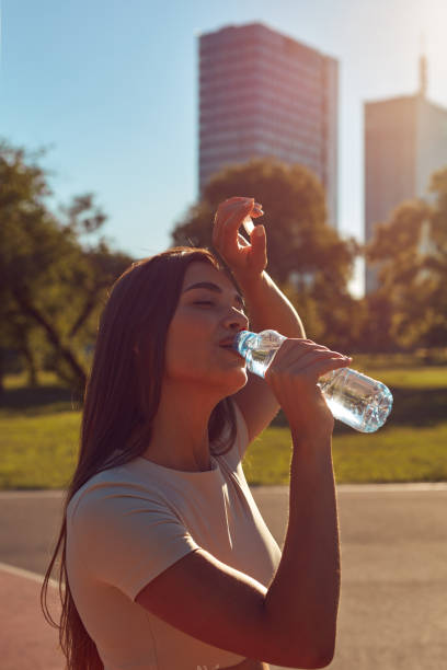 istock Young woman drinking water after jogging and exercise in urban p 2193656232