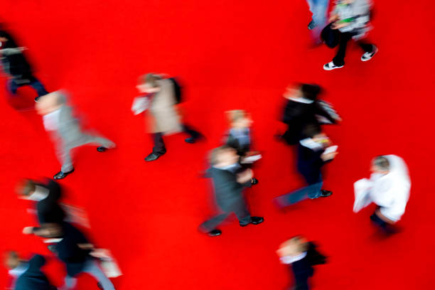 istock Crowd of Blurred People Walking Fast on Red Carpet 2193656329