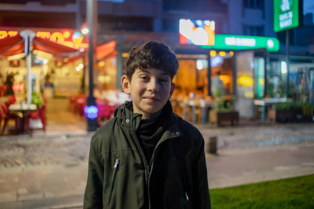 Portrait of a happy and cute child with smiling face in winter at night.