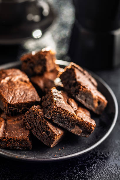 istock Homemade chocolate brownies on plate on black table. 2193660440