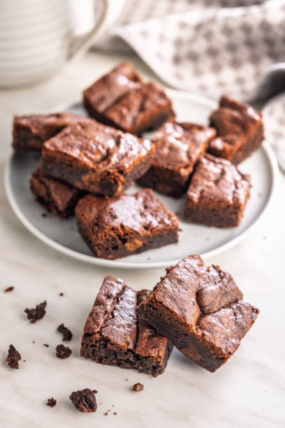 istock Homemade chocolate brownies on plate on kitchen table. 2193660802