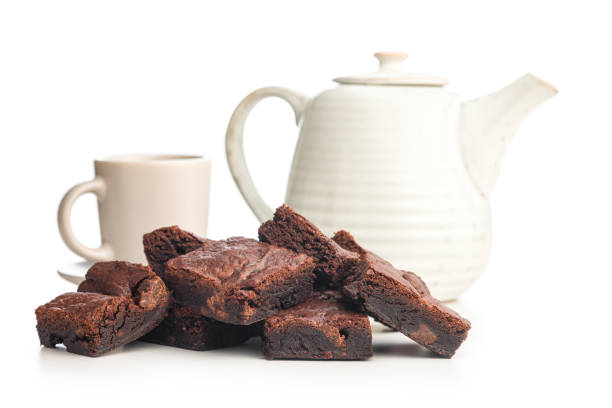 Homemade chocolate brownies and coffee cup isolated on a white background.