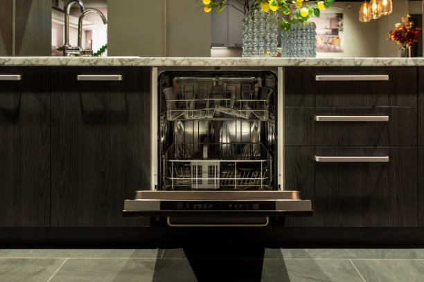istock Modern kitchen dishwasher with open door and wooden cabinets 2193663809
