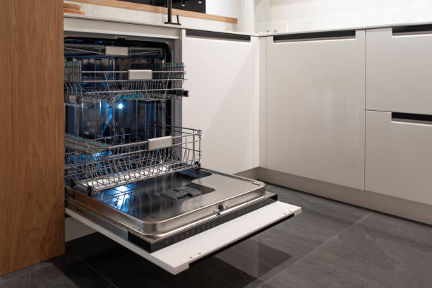 istock Open dishwasher with metal racks in sleek gray kitchen cabinetry 2193663817