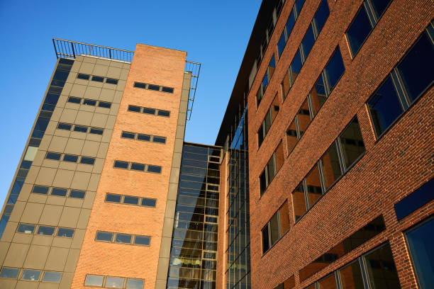 istock Office building exterior with brick facade and glass windows 2193665995