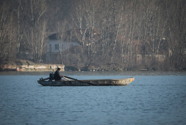 In the morning, the boat with the fisherman. Romania, Orsova. January, 06, 2025