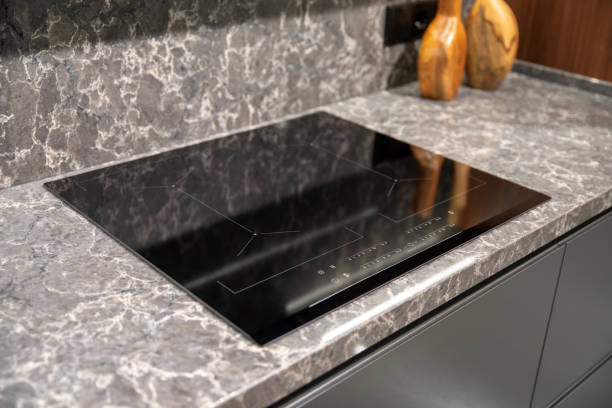 istock Contemporary kitchen features an elegant induction cooktop on marble surface 2193667262
