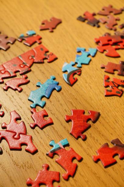 istock Colorful puzzle pieces on a wooden table 2193667360