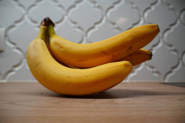 istock Ripe bananas on a wooden countertop 2193667391