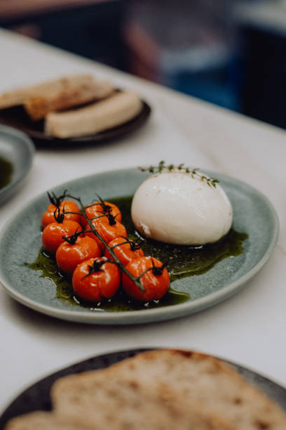 istock Burrata with Tomato Confit and Pesto Appetizer 2193667719