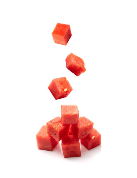 istock Falling Watermelon cubes isolated. Water melon cube pile, flying chopped Citrullus lanatus 2193667728