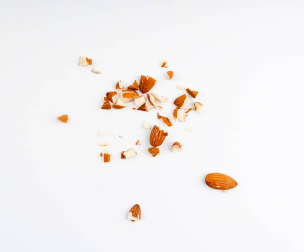 istock Crushed almonds isolated, nut pieces, sliced scattered almond seeds and cut kernels collection on white background 2193667978