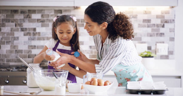 istock Help, mom and child with kitchen, baking and learning with ingredients for pastry or dessert cake. Smile, happy mother and teaching cooking daughter for pudding, cookies or recipe prepare in home 2193668668