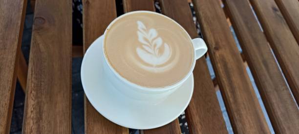 istock cup of coffee with a leaf design on the foam 2193669388