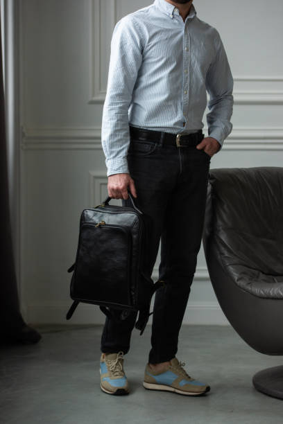 istock A Stylish and Professional Man Standing with a Bag in a Contemporary Modern Setting 2193669482