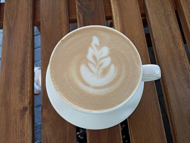 istock cup of coffee with a leaf design on the foam 2193669578