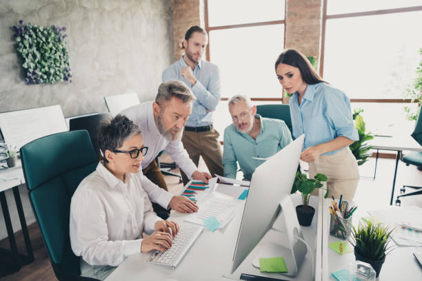 istock Photo of teamwork startup partners people computer networking discussion meeting comfortable creative startup office loft room interior 2193670350
