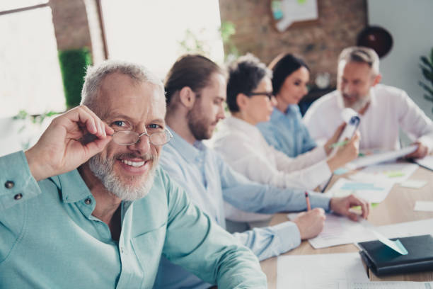 istock Photo of teamwork startup partners confident senior man boss look camera comfortable nice creative startup office loft room interior 2193670748