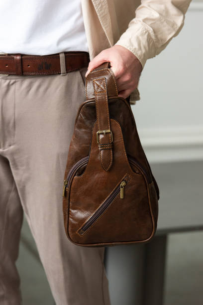 istock A Stylish and Professional Man Standing with a brown hip pack in a Contemporary Modern Setting. 2193672341