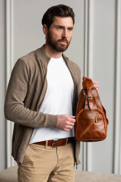 istock A Stylish and Professional Man Standing with a yellow brown hip pack 2193672542