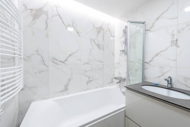Modern Bright White Bathroom With Stylish Marble Tiles and Functional Fixtures. Home Interior