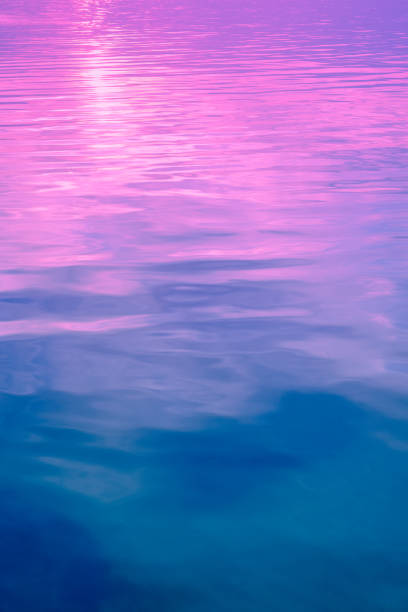 istock Sea water surface. View from above. Artistic pink-blue gradient color. Vertical banner 2193678378