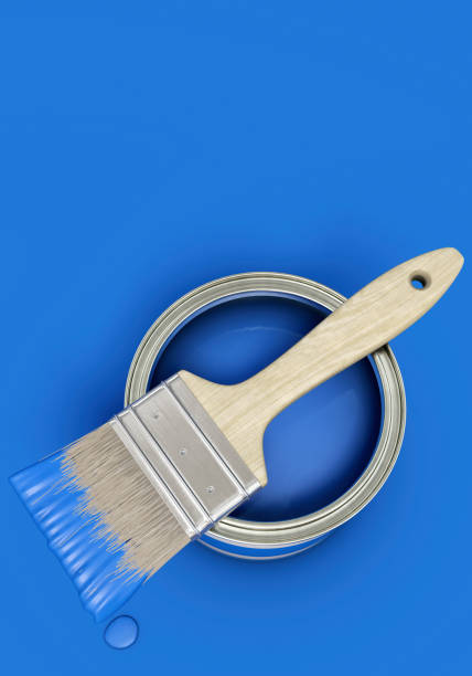 istock Blue paint can with brush on blue background, portrait format 2193681265