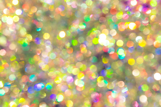 Radiant multicolor bokeh background with glitter highlights evoking festive and joyful feelings.