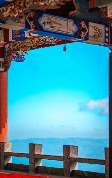 istock Intricate, colorful Chinese architecture frames a vibrant Yunnan sky. Dali's mountain range is visible in the distance, offering a breathtaking view. 2193682766