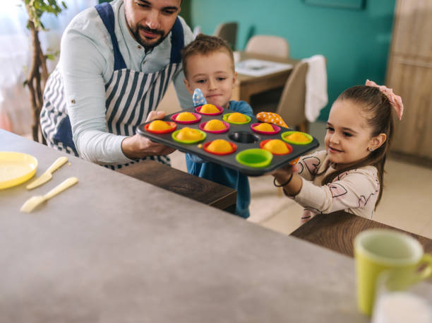 istock A young father is preparing breakfast at home with his children. 2193684291