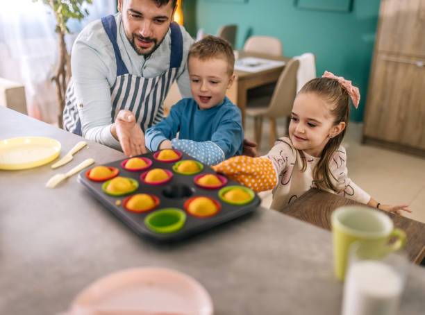 istock A young father is preparing breakfast at home with his children. 2193684302