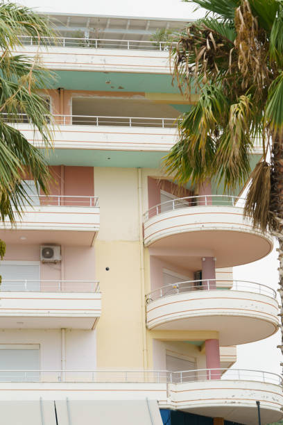 istock Vertical image modern minimalist apartment buildings in Mediterranean style with palm trees in Albania near the sea coast. Concept of foreign real estate, digital nomads, apartment rental in resort 2193684461