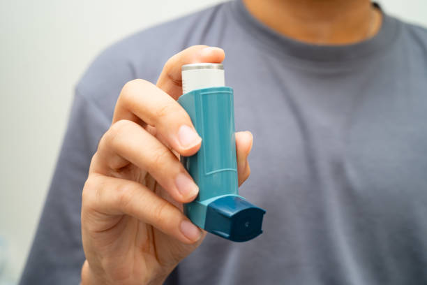 istock Asthma and chronic obstructive pulmonary disease COPD, Asian young man using metered dose inhaler MDI. 2193685014