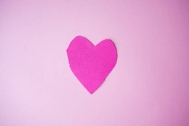 istock Pink heart shape on light pink background 2193686857