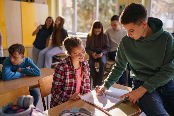 istock A boy explains mathematics to a girl in the classroom 2193687289